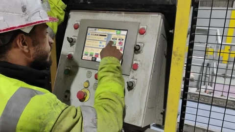 4K Factory Worker Operating a Human-Machine Interface Panel for Bag Palletizing. Stock Footage 331940176