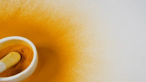 4k falling Aromatic Turmeric powder on mortar and pestle on white background Stock Footage 88475393