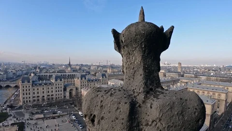 4K, Famous stone gargoyle statue in Notre Dame Cathedral with city of Paris.-Dan Stock Footage 106908381