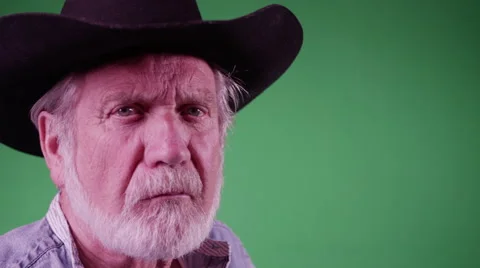 4K Farmer looks at the camera and squints in front of green screen Stock Footage 45733100