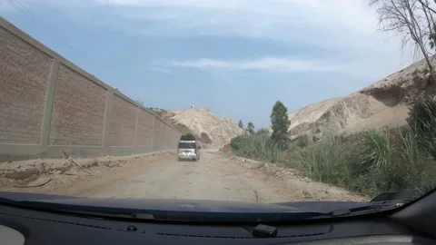 4k fast camera point of view of a car camera going off a dirt road to a paved ro Stock Footage 144349556