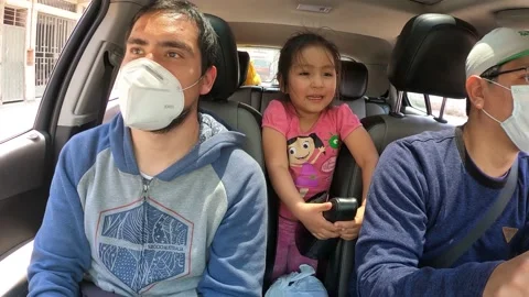 4k fast camera point of view of a family traveling with a mask inside a car Stock-Footage 144354620
