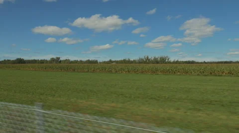 4k - Fast moving camera near a farm field and blue sky Stock Footage 67407325