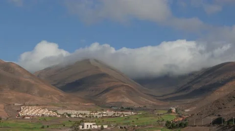 4K Fast moving clouds over mountains in Fuerteventura 400% speed Stock Footage 68804819