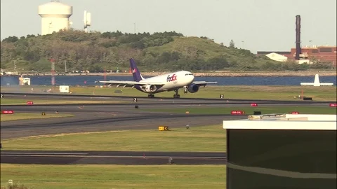 4K FedEx cargo mail plane lands on airport runway Stock Footage 91332043