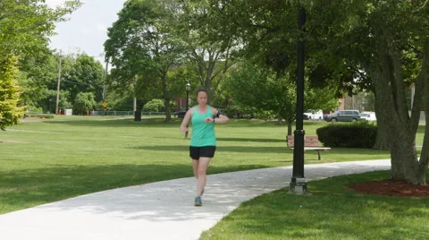 4K Female Athlete Checking Smart Watch While Running Stock Footage 63522431