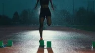 4K Female Athlete Training At Running Track In The Dark &Amp; In The Rain. Slowmo Stock Footage