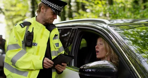 4K Female driver making excuses to policeman to try and avoid getting a ticket Stock Footage 113691790