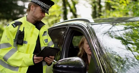 4K Female driver making excuses to policeman to try and avoid getting a ticket Stock Footage 113692585