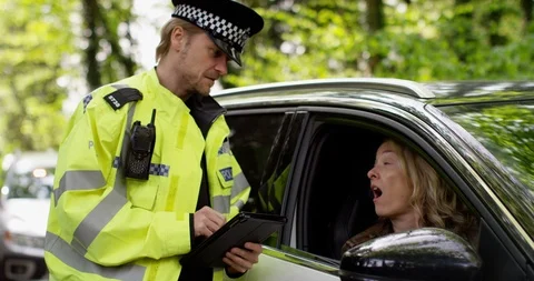 4K Female driver trying to talk her way out of a ticket for traffic offence Stock Footage 113133580