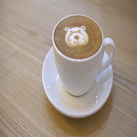 4K Female Hands Hold Cup Of Coffee with a face bear shape for breakfast.-Dan 스톡 동영상 69458341
