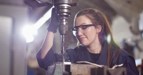 4K Female technician operating smoking hot drilling machine in metal workshop Stock Footage 103865647
