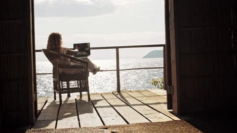 4k of Female working on laptop computer, touch screen technology on balcony of b Stock-Footage 199626856