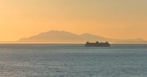 4K Ferry at Dusk Sun Setting Over Ocean Orange Silhouette Stock Footage 46972641