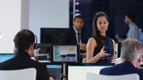 4K Financial manager in stock exchange overseeing staff & giving instructions Stock Footage