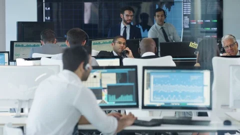 4K Financial trader in busy stock exchange celebrates making a successful deal Stock Footage