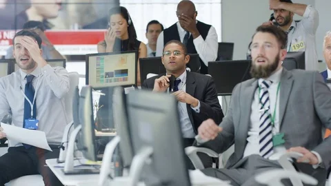 4K Financial traders watching the world markets react as the market crashes Stock Footage 72277321