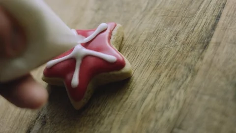 4K Fine White Lines Completed on a Red Star Gingerbread Cookie Stock Footage 342113677