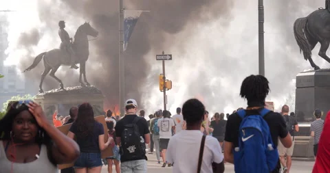 4K FIRE BURNING WITH PROTESTERS AND MONUMENT Stock Footage 131453883