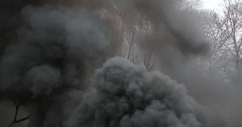 4K Fire Thick Smoke Billowing From Burning Firepit Plane Crash Pan Up Vidéo 307128191