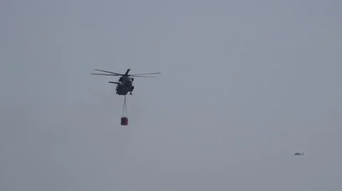 4k Firefighting helicopter throws water demonstration at airshow exhibition Stock Footage 64322266