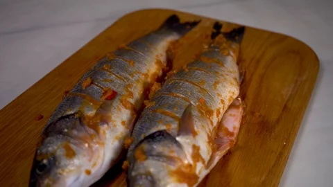 4K, fish; food; kitchen; animal; hand; man;white; healthy;seabass; raw; seafood; Stock Footage 100350053