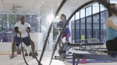 4K Fit group working out in the gym, video screen showing moving outdoor scene Stock Footage 75869802