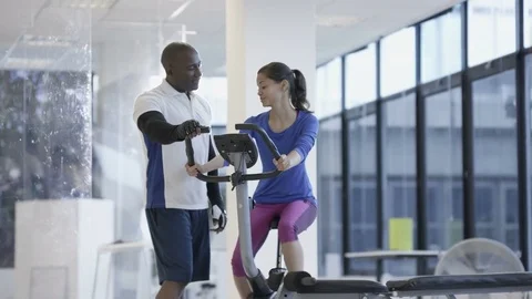4K Fit group working out in the gym, video screen showing moving outdoor scene Stock Footage 75870987