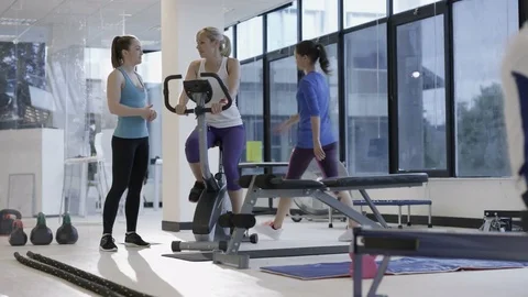 4K Fit group working out in the gym, video screen showing moving outdoor scene Stock Footage 75871615