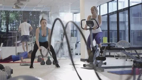 4K Fit group working out in the gym, video screen showing moving outdoor scene Video stock 75872015