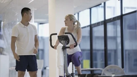4K Fit group working out in the gym, video screen showing moving outdoor scene Stock Footage 75874823