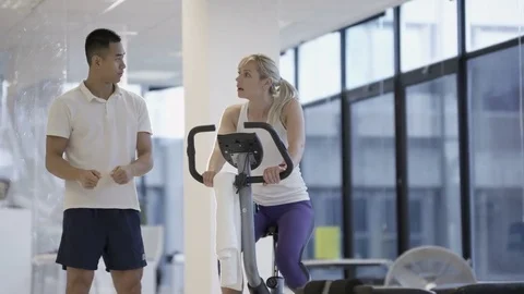 4K Fit group working out in the gym, video screen showing moving outdoor scene Stock Footage 75874958