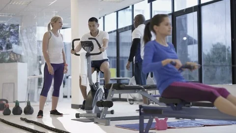 	4K Fit group working out in the gym, video screen showing moving outdoor scene Video stock 75876146