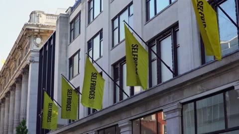 4k Flags on the Selfridges store on Oxford street in London Stock Footage 145104406