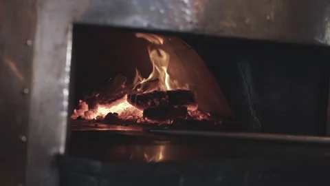 4k flame brewing inside a pizza oven Stock Footage 338429636