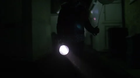 4K Flashlight held by a child walking a street at night, in slow motion Stock Footage 56568736