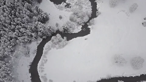 4K. Flight above clouds and wild winding river in frozen forest. Aerial view. 스톡 동영상 83317270