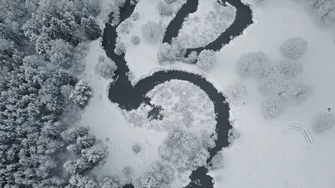 4K. Flight above clouds and wild winding river in frozen winter forest. Aerial. 스톡 동영상 83321939
