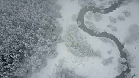 4K. Flight above clouds and wild winding river in winter forest. Aerial view. Video stock 83325994