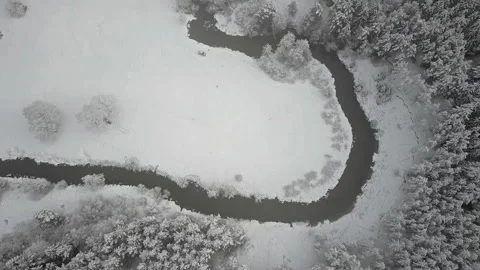 4K. Flight above clouds and wild winding river in frozen forest. Aerial. Video stock 97963716