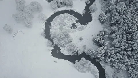 4K. Flight above clouds and wild winding river in frozen forest. Aerial. Video stock 97963765