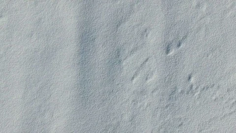 4K. Flight above snow fields in winter, aerial top view. White snow texture. Stock Footage 72731518