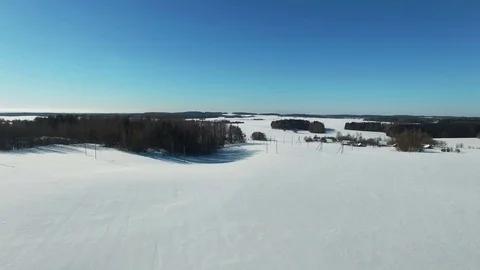 4K. Flight above snow fields in winter, aerial panoramic view. Winter land. 動画素材 72732063