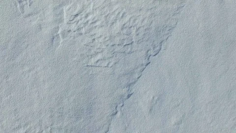 4K. Flight and takeoff above snow fields in winter, aerial top view. Video stock 72730460