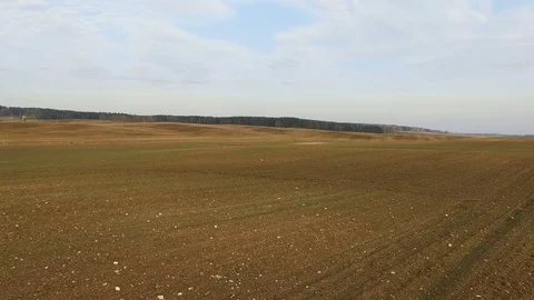 4K. Flight and takeoff above freshly cultivated fields in spring, aerial view. Stock-Footage 73531056