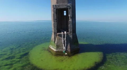 4K. Flight and takeoff over old lighthouse standing in the sea, aerial view. 스톡 동영상 63070881
