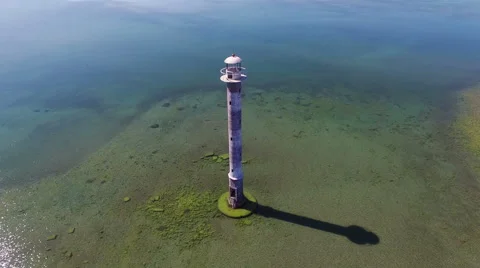 4K. Flight and takeoff over old lighthouse standing in the sea, aerial view. Stock-Footage 63071689