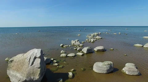 4K. Flight and takeoff over the sea with stones standing in the water, aerial. 스톡 동영상 63120977