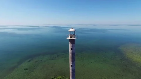 4K. Flight and takeoff over old lighthouse standing in the sea, aerial view. 動画素材 72183189