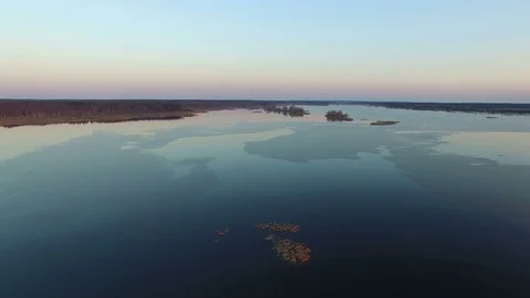 4K. Flight and takeoff over wild frozen lake in winter on sunset, aerial view. 動画素材 82179407